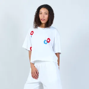 White t-shirt with crochet flower accents wholesale